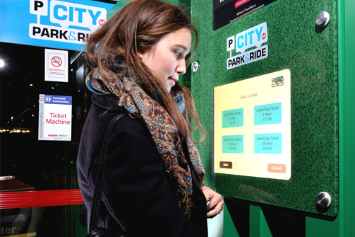 Lady paying for City Park & Ride Bus at Ticket Kiosk